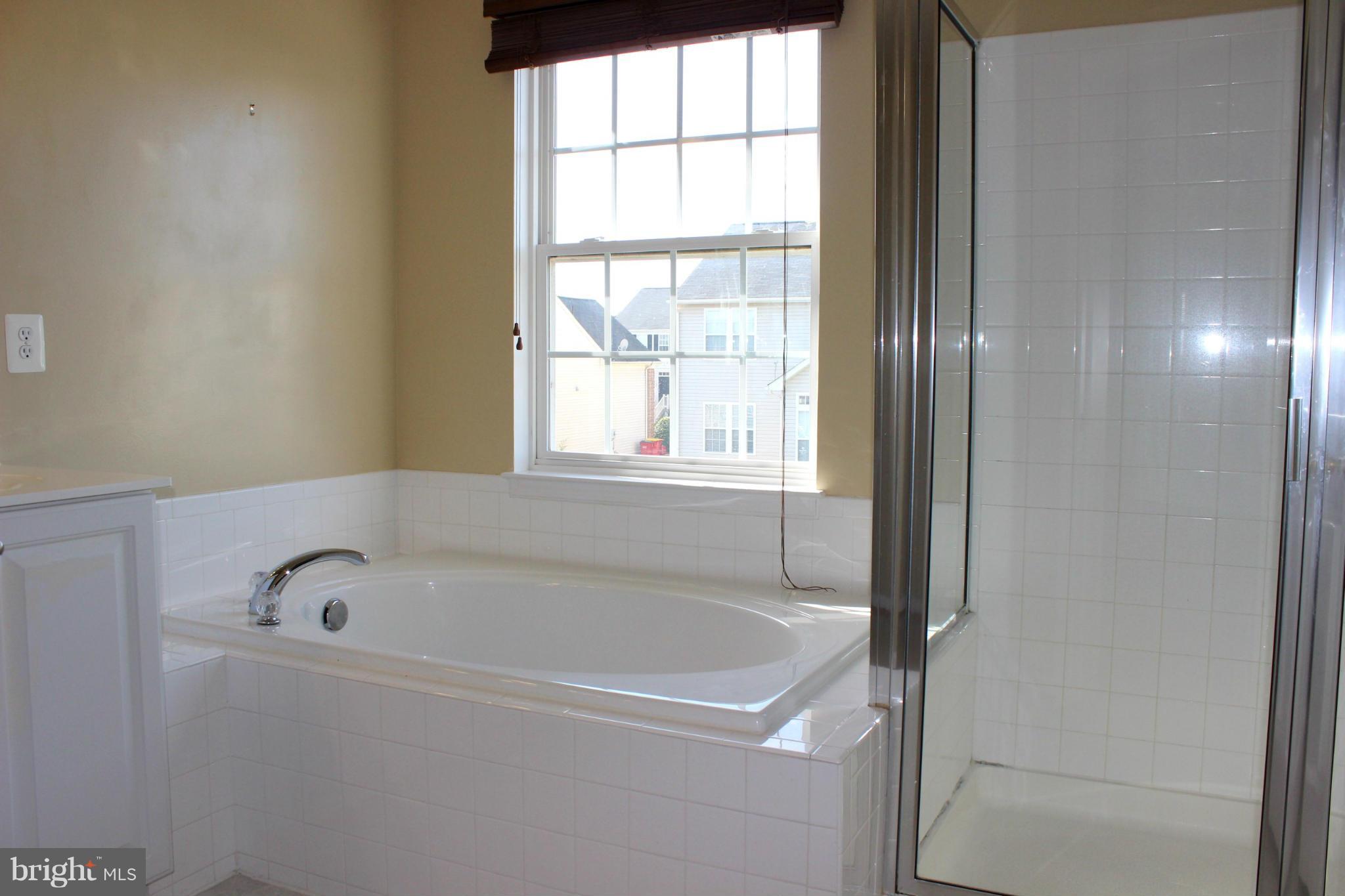 1319 Steed Street Ranson, WV 25438 - Photo 19 of 22 a white bath tub sitting next to a window