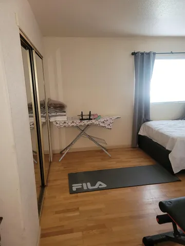 a large bed sitting in a bedroom next to a window