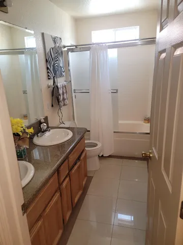 a bedroom with a bed and ceiling fan