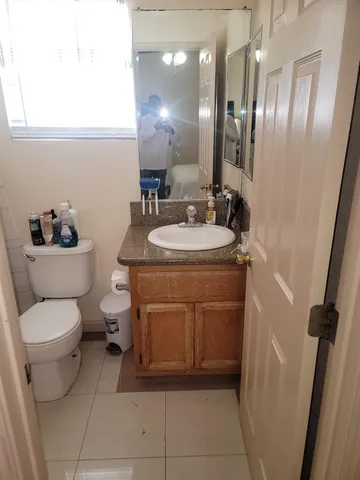 a white toilet sitting next to a shower curtain