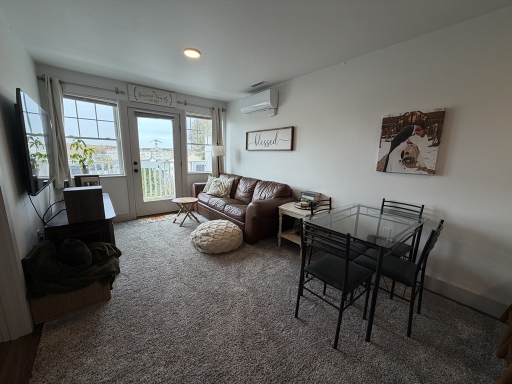 5 West Dane Street, Unit 7 Beverly, MA 01915 - Photo 3 of 14 a living room with furniture and a flat screen tv
