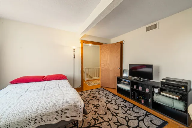 a bedroom with a bed and a flat screen tv