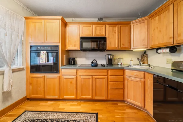 a kitchen with stainless steel appliances granite countertop a refrigerator and cabinets