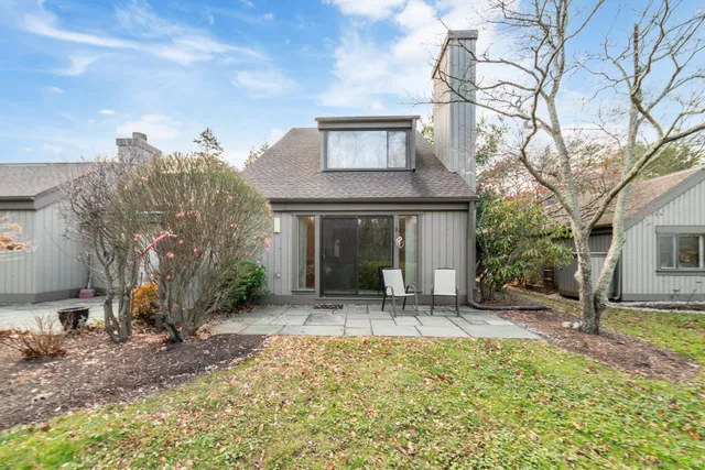 a front view of house with a garden