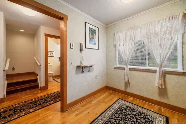 a view of a room with window and hardwood floor