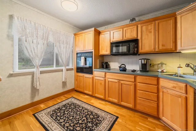 a kitchen with stainless steel appliances granite countertop a refrigerator sink and cabinets