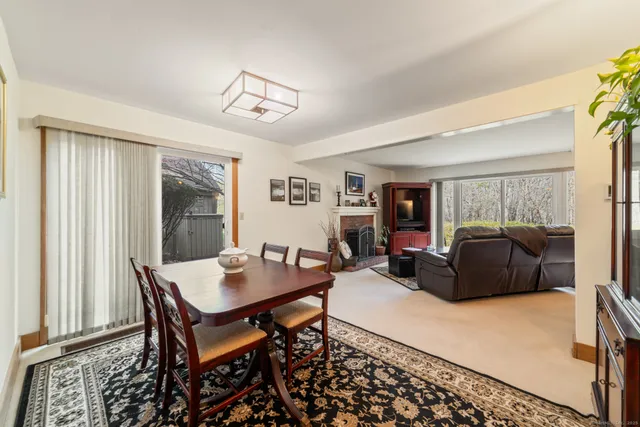 a living room with furniture a flat screen tv and a window
