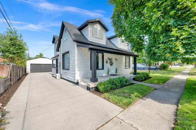 446 South 300 East Provo, UT 84606 - Photo 2 of 32 White siding exterior with black trim accents and a covered front porch featuring dark columns