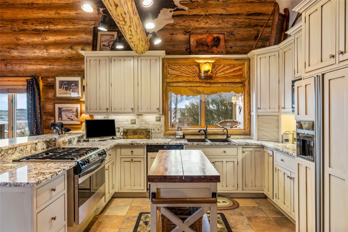 32790 Hidden Pond Path Steamboat Springs, CO 80487 - Photo 11 of 31 a kitchen with a stove a sink and a refrigerator