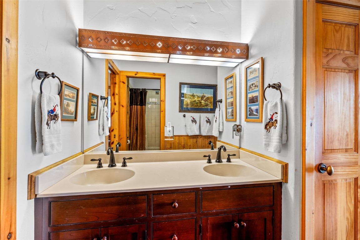 32790 Hidden Pond Path Steamboat Springs, CO 80487 - Photo 24 of 31 a bathroom with a sink and a mirror