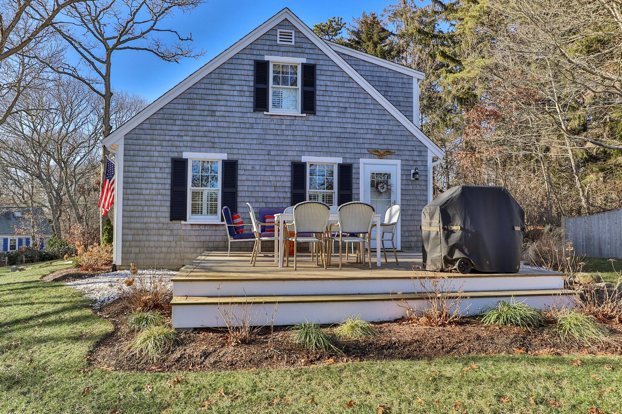 76 Headwaters Road Centerville, MA 02632 - Photo 49 of 53 a front view of house with yard and seating area
