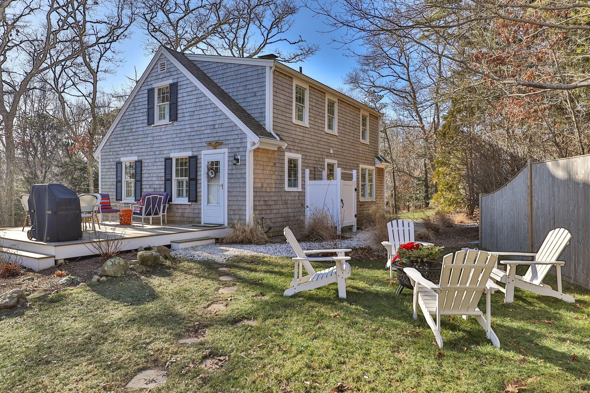 76 Headwaters Road Centerville, MA 02632 - Photo 8 of 53 a backyard of a house with table and chairs