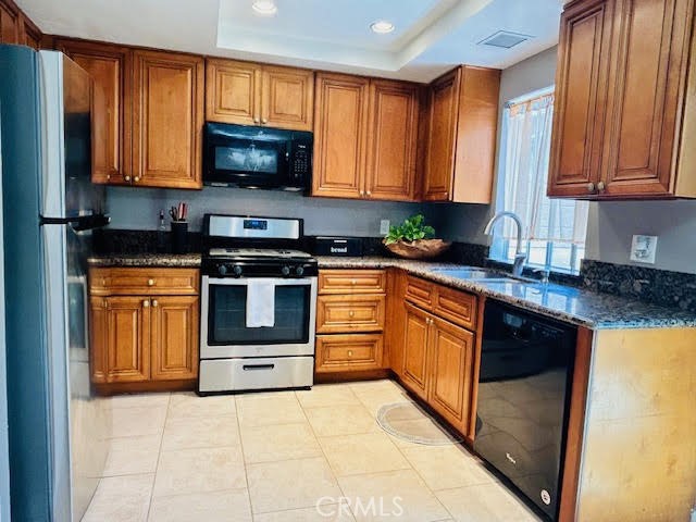 7304 Exeter Street, Unit E Paramount, CA 90723 - Photo 1 of 36 The bright, open kitchen is beautifully appointed with recessed lighting, tile flooring, granite countertops, and a stainless steel refrigerator and range.