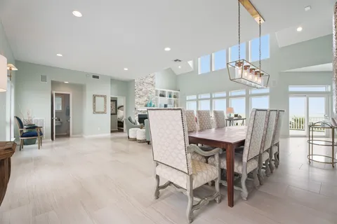 a dining area with furniture and a large window