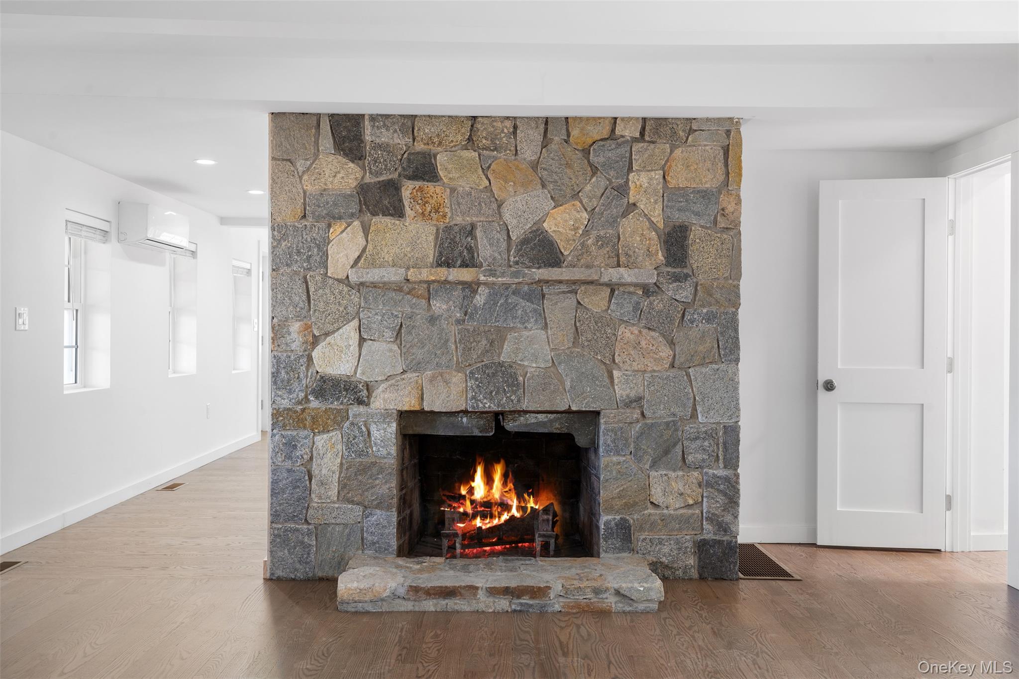 70 Barmore Road LaGrangeville, NY 12540 - Photo 14 of 47 Detailed view of a fireplace, wood finished floors, and a wall mounted AC