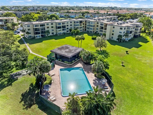 an aerial view of a house with a swimming pool yard and mountain view