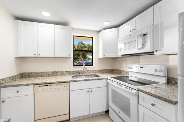 a kitchen with a stove a sink and a refrigerator