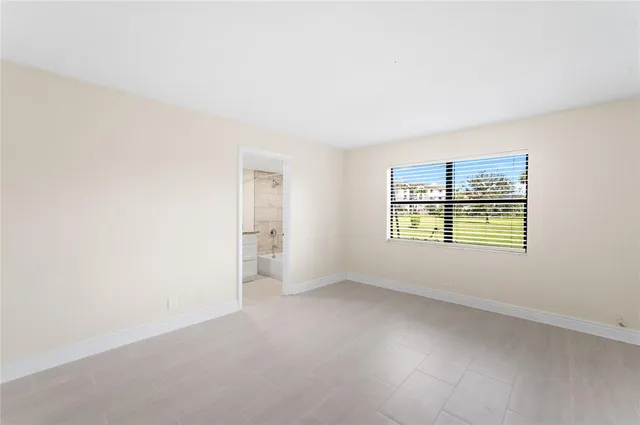a bathroom with a granite countertop sink a toilet and bathtub