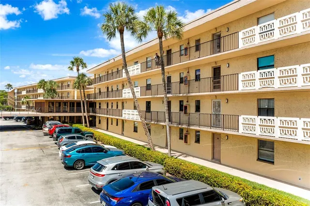a building outdoor space with lots of trees in front of it