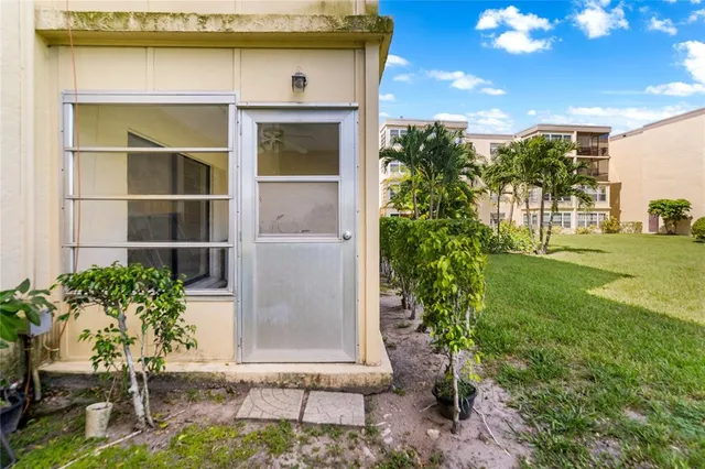 a view of a swimming pool with couches and wooden fence