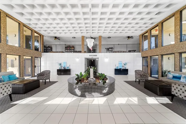 a living room with furniture fireplace and a large window