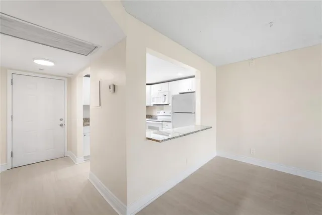 a view of a kitchen from the hallway