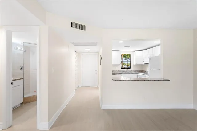 a kitchen with granite countertop a sink and a stove