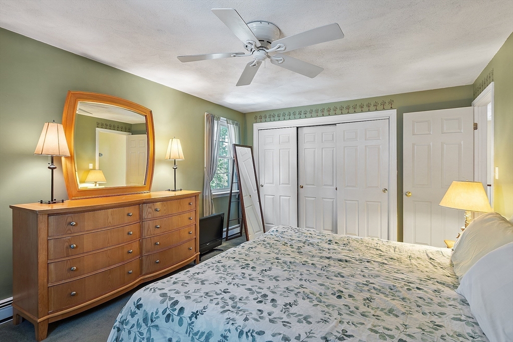 145 Virginia Road Waltham, MA 02453 - Photo 19 of 36 a spacious bedroom with a bed and a dresser