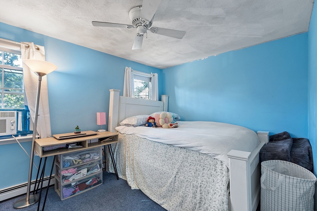 145 Virginia Road Waltham, MA 02453 - Photo 21 of 36 a bedroom with a bed and a desk