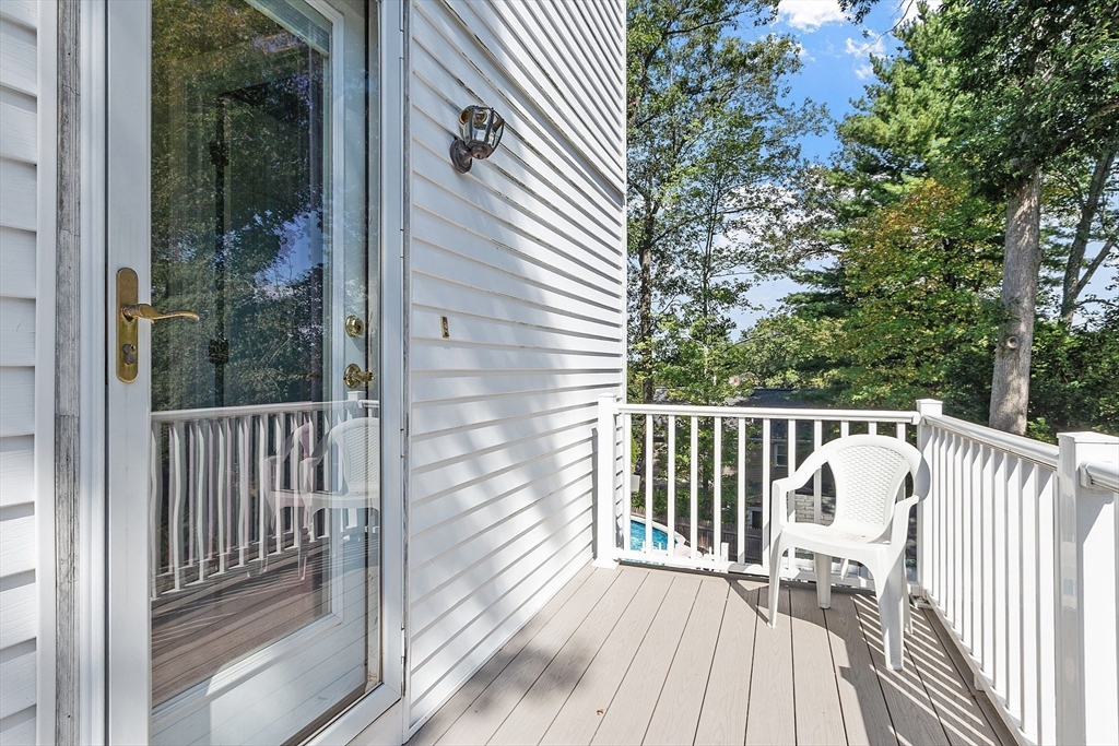 145 Virginia Road Waltham, MA 02453 - Photo 26 of 36 a balcony with wooden floor table and chairs