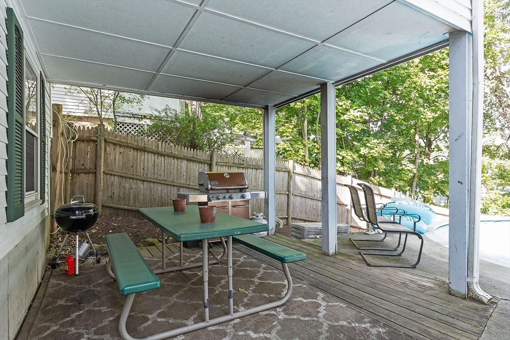 145 Virginia Road Waltham, MA 02453 - Photo 33 of 36 a patio with glass top table and chairs