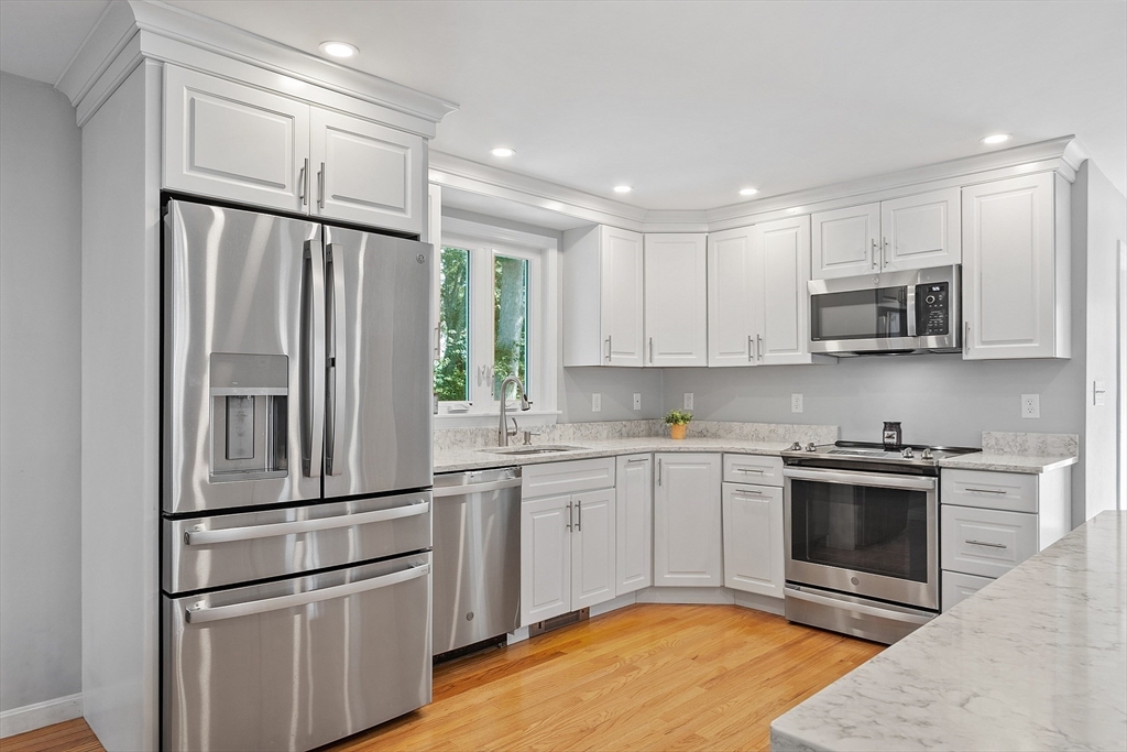 145 Virginia Road Waltham, MA 02453 - Photo 5 of 36 a kitchen with granite countertop a refrigerator and a sink