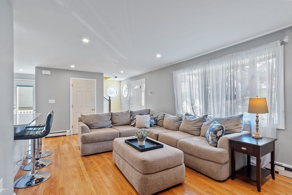 145 Virginia Road Waltham, MA 02453 - Photo 10 of 36 a living room with furniture and a lamp