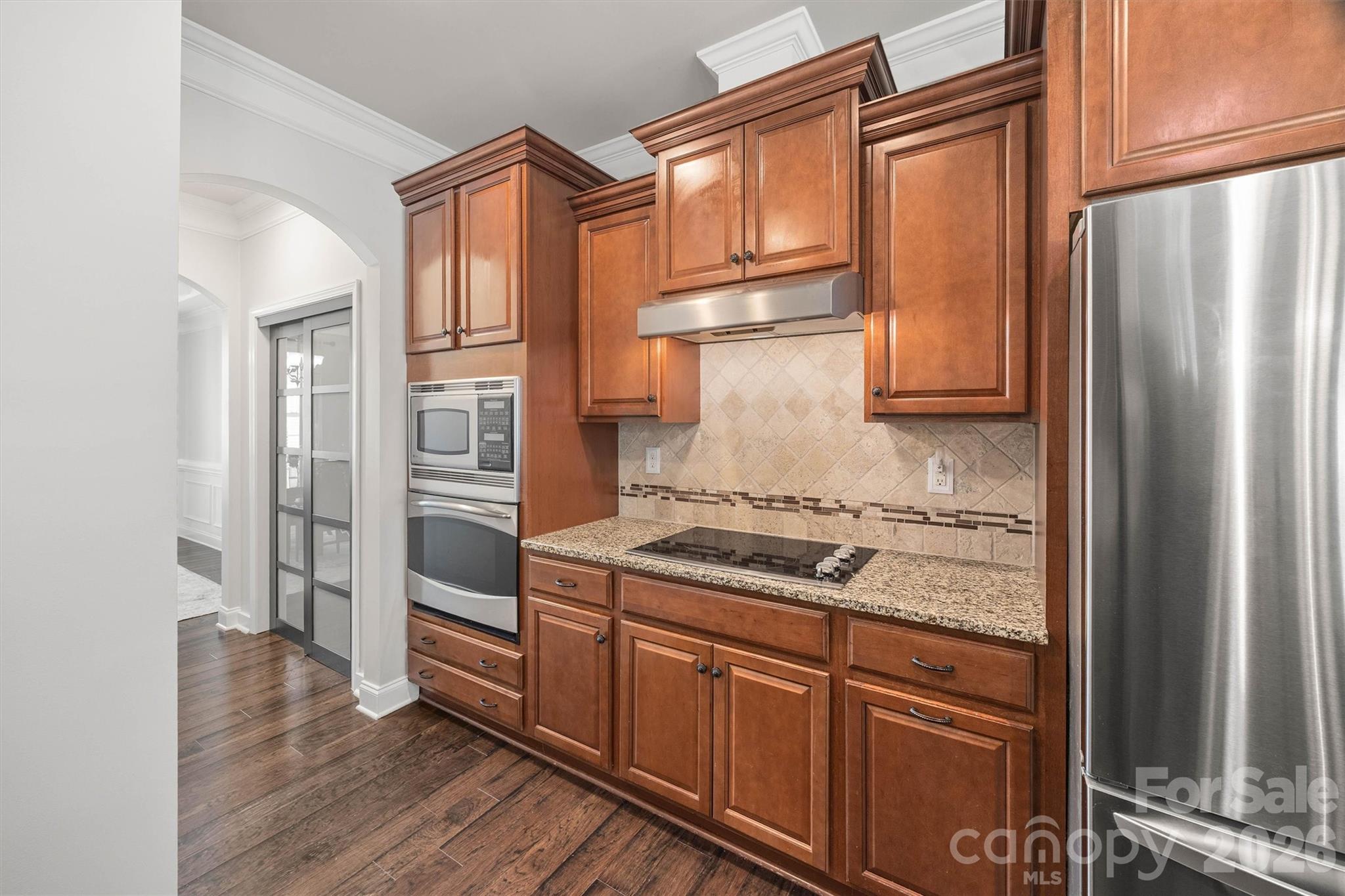 299 Annatto Way Tega Cay, SC 29708 - Photo 12 of 46 a kitchen with stainless steel appliances granite countertop a refrigerator and a stove