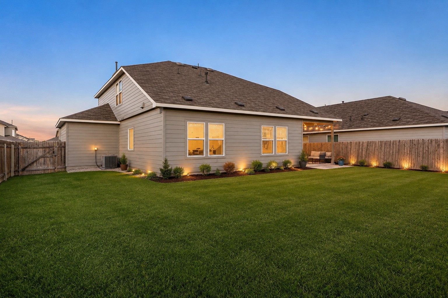 207 Otter Road Kyle, TX 78640 - Photo 20 of 26 Manicured grass highlights the spacious backyard of this contemporary two-story residence.