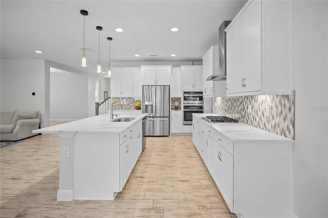 a large white kitchen with a large window