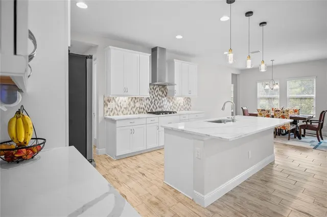 a hallway with a couch and chandelier
