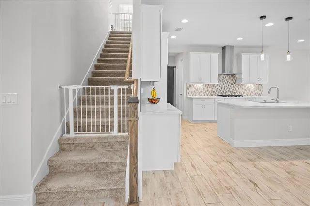 an entryway in a room with furniture and a flat screen tv