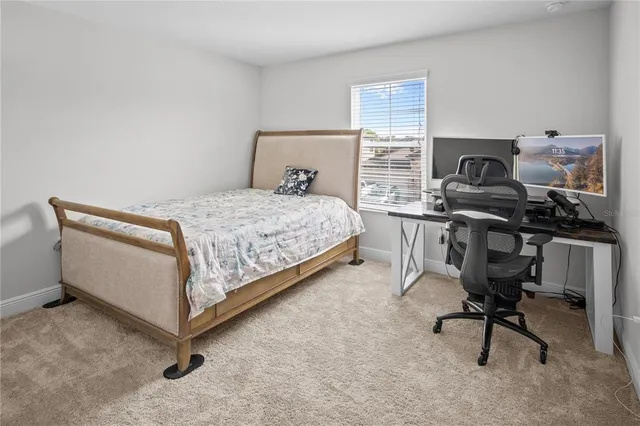 a bedroom with a bed and ceiling fan