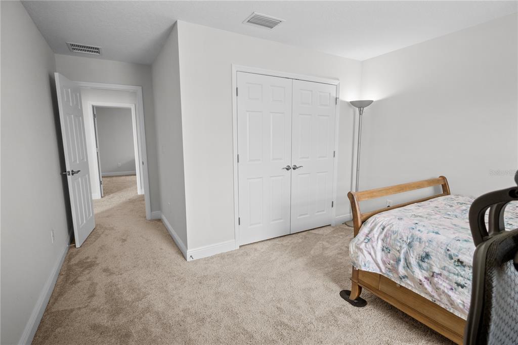 14654 Horse Trot Road Lithia, FL 33547 - Photo 25 of 53 a bedroom with a bed and a mirror