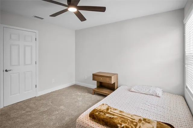 a living room with a bed furniture and a window