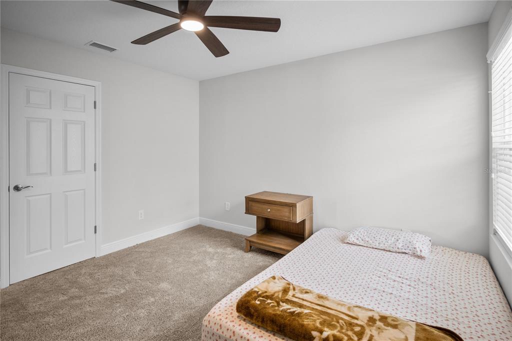 14654 Horse Trot Road Lithia, FL 33547 - Photo 27 of 53 a bedroom with a bed and ceiling fan