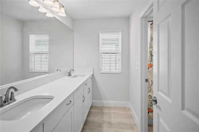 a bedroom with a bed couches and white walls