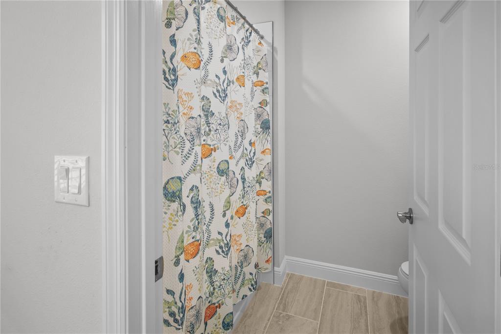 14654 Horse Trot Road Lithia, FL 33547 - Photo 29 of 53 a bathroom with a shower curtain
