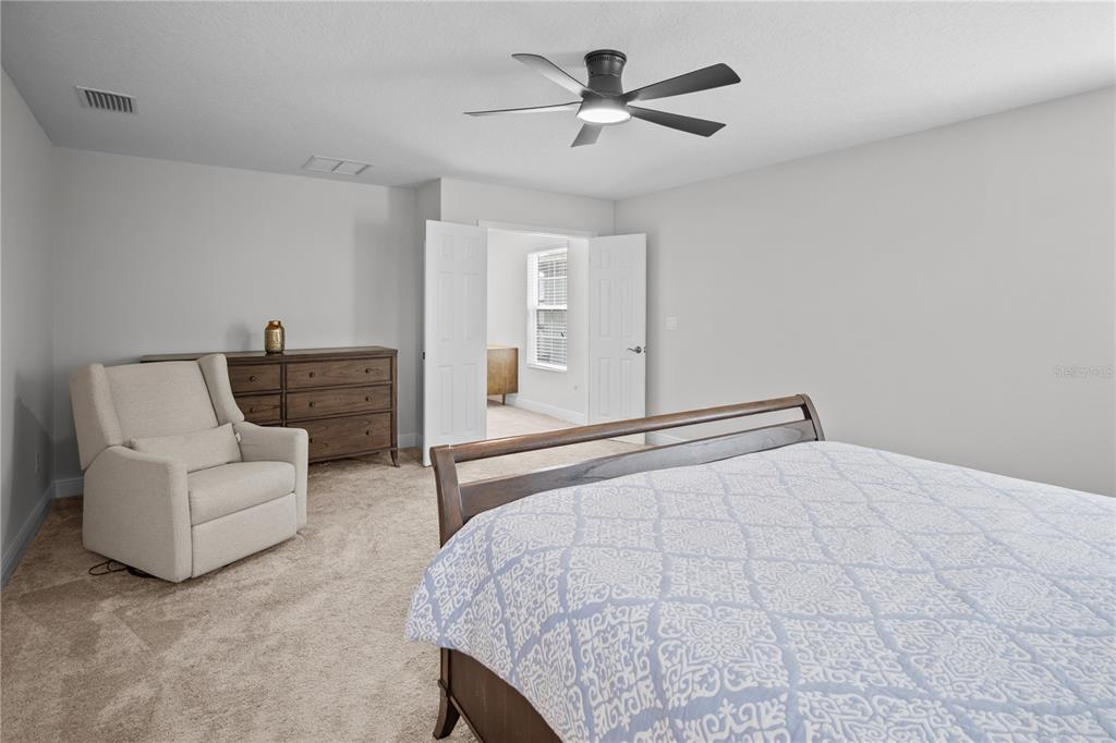 14654 Horse Trot Road Lithia, FL 33547 - Photo 31 of 53 a bedroom with a bed couches and white walls