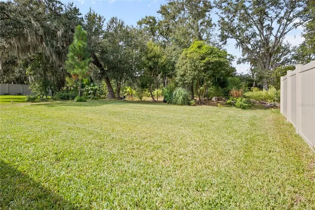 an aerial view of a house with a yard pool outdoor seating and yard