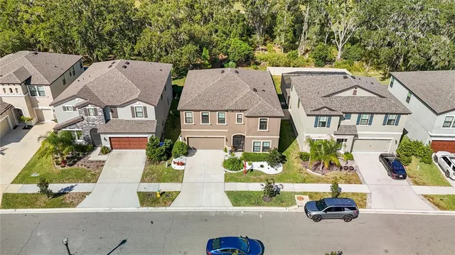an aerial view of residential house with pool and outdoor space