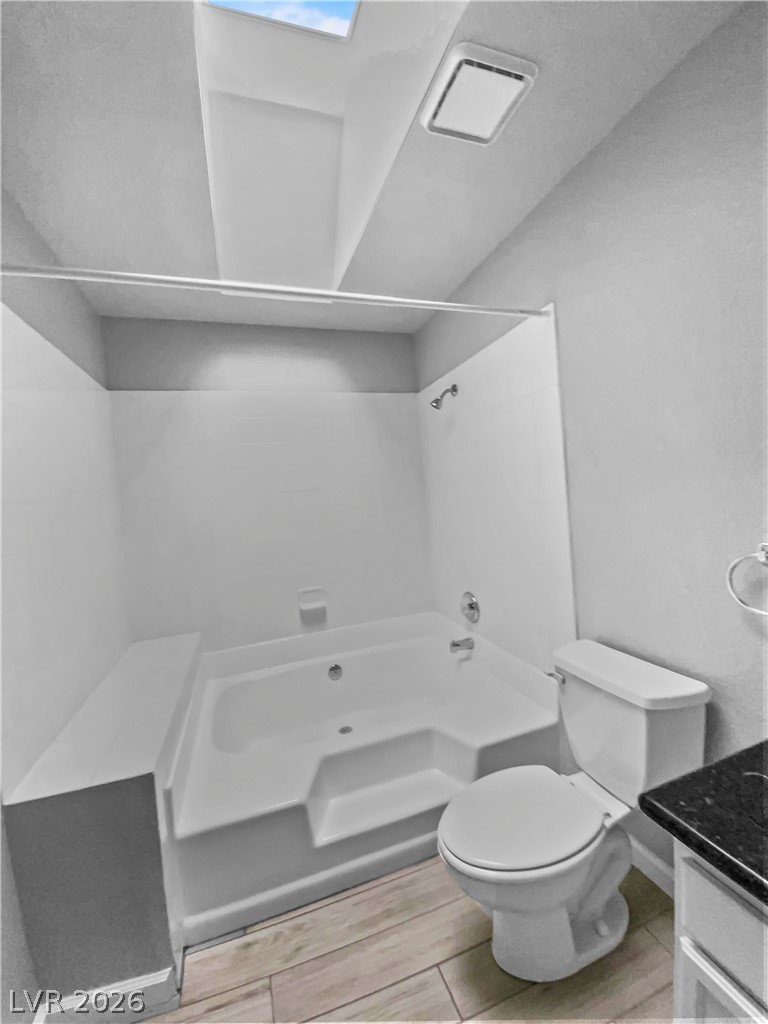 9325 West Desert Inn Road, Unit 278 Las Vegas, NV 89117 - Photo 9 of 17 A well-lit bathroom features a deep soaking tub and sleek modern toilet.