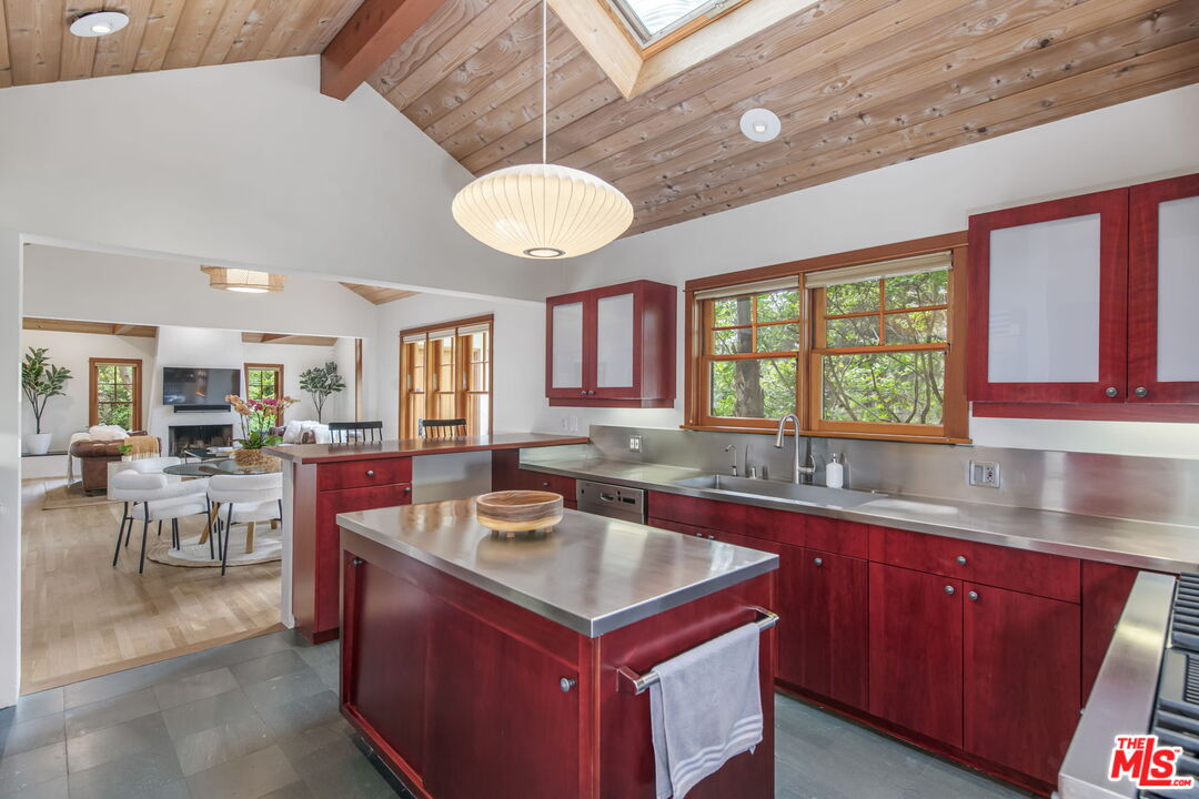 27 Latimer Road Santa Monica, CA 90402 - Photo 11 of 37 a kitchen with a stove a sink a cabinets and chairs