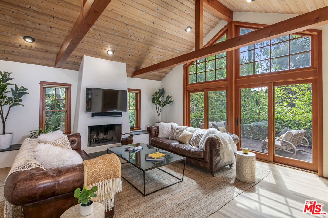 27 Latimer Road Santa Monica, CA 90402 - Photo 3 of 37 a living room with furniture fireplace and a large window